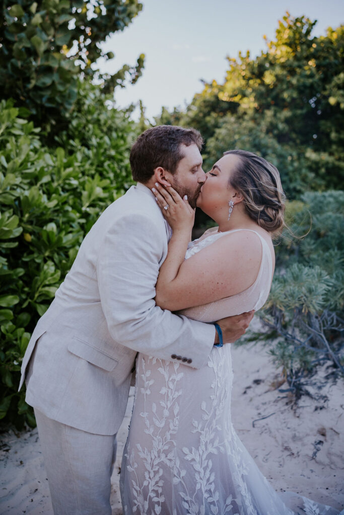 Destination Wedding Photographer captures bride kissing groom after Cancun wedding ceremony