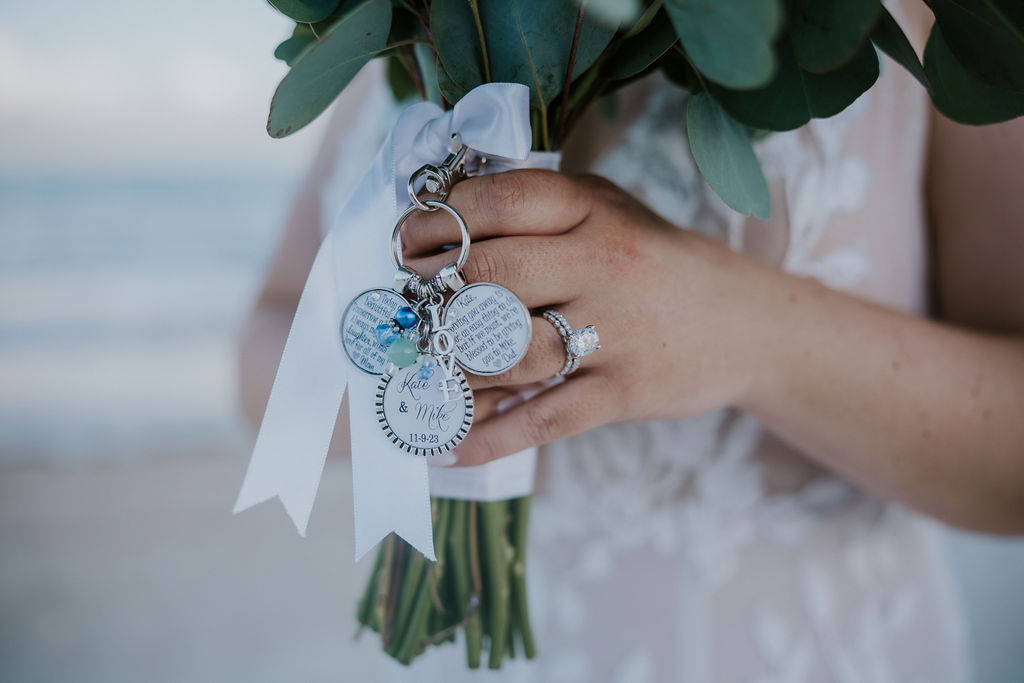 Destination wedding photographer captures bridal bouquet with charms hanging from bouquet