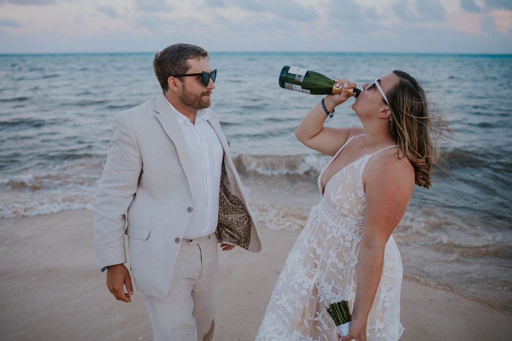 Destination wedding photographer captures bride drinking champagne from bottle