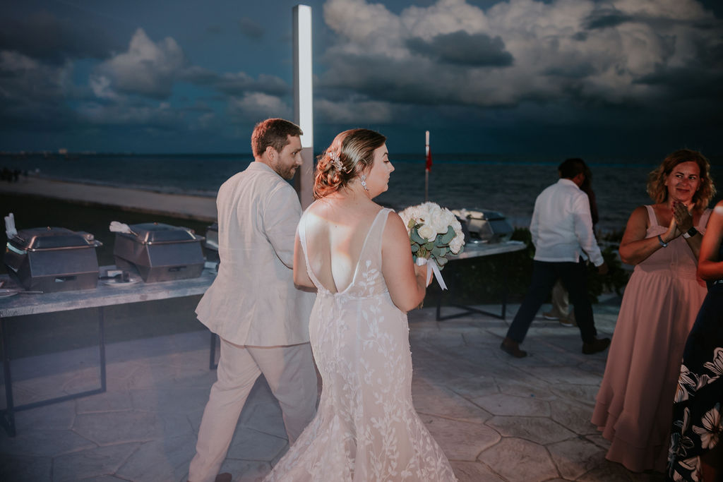 Destination wedding photographer captures couple walking into wedding reception