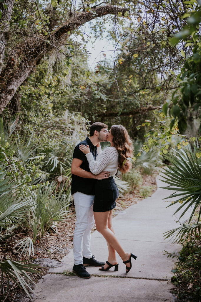 Destination Wedding Photographer captures man and woman embracing during destination engagement photos in Florida