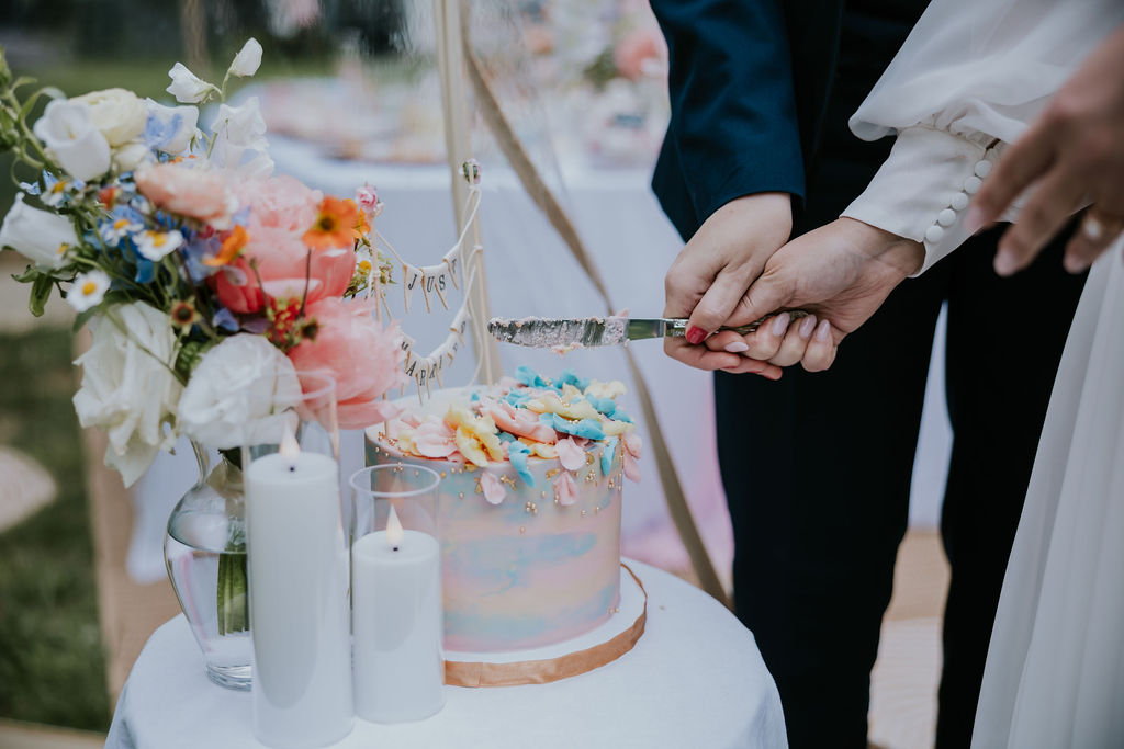 Nashville Elopement Photographer captures couple cutting cake at tea party