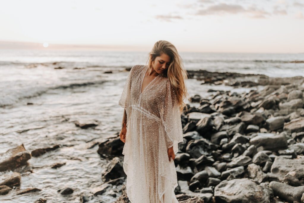 Destination Wedding Photographer captures bride wearing flowy wedding dress before Hawaii beach wedding