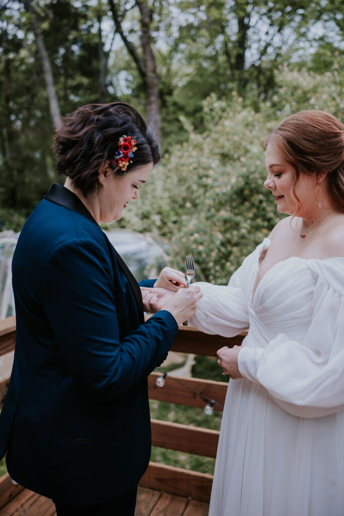 Nashville Elopement Photographer captures bride helping bride put bracelet on her wrist