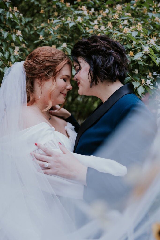 Nashville Elopement Photographer captures bride touching noses with veil blowing in wind