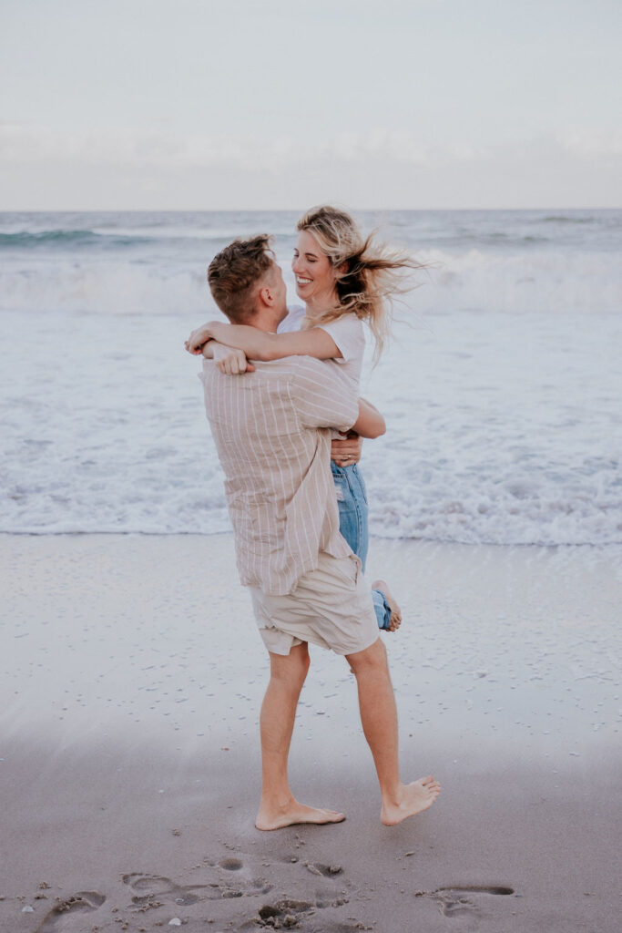 Destination Wedding Photographer captures couple playing on the beach before destination wedding in Florida