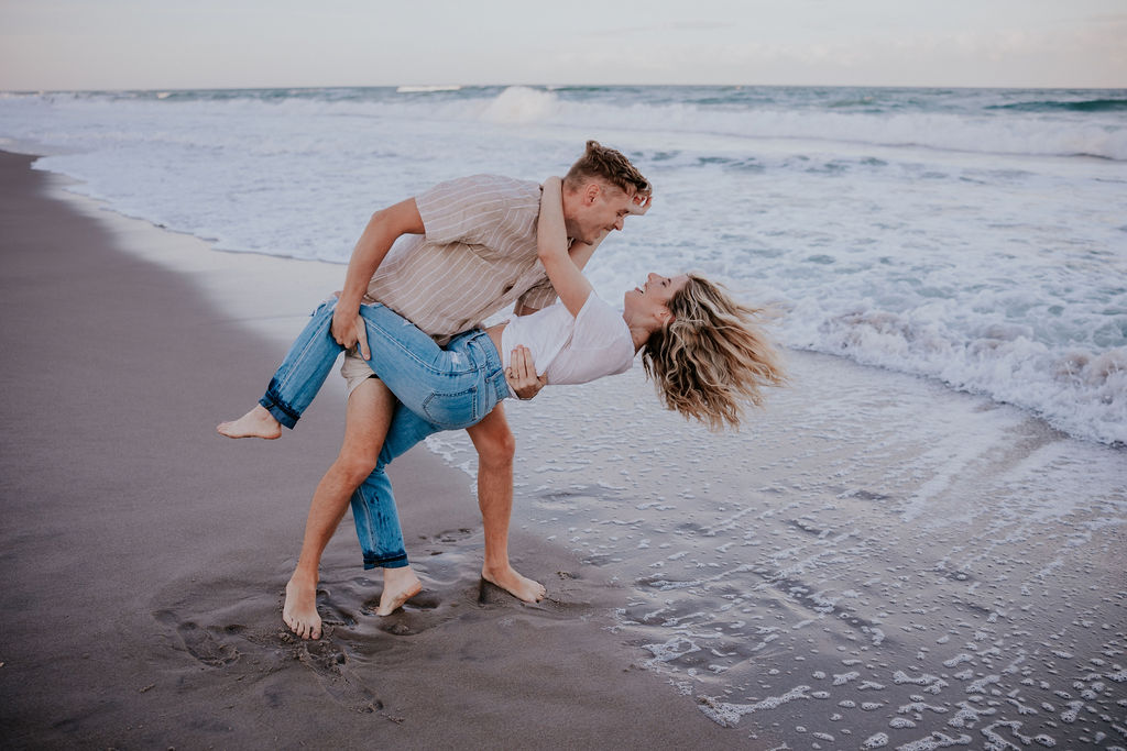 Destination Wedding Photographer captures couple laughing at playing in water