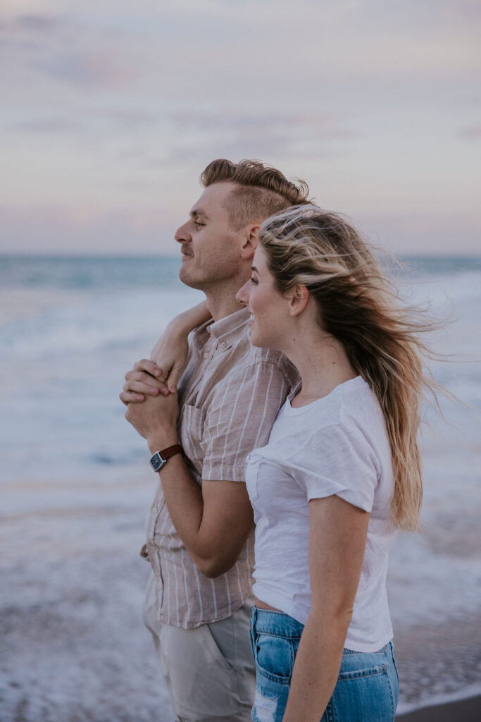 Destination Wedding Photographer captures woman with arm around man's shoulder