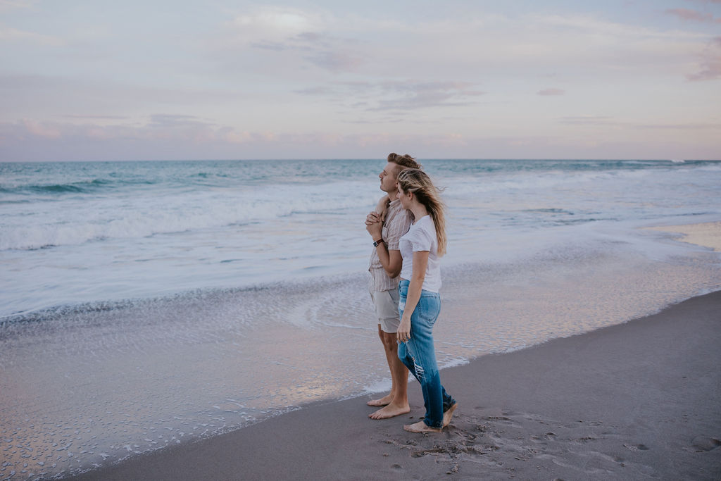 Destination Wedding Photographer captures couple looking at waves