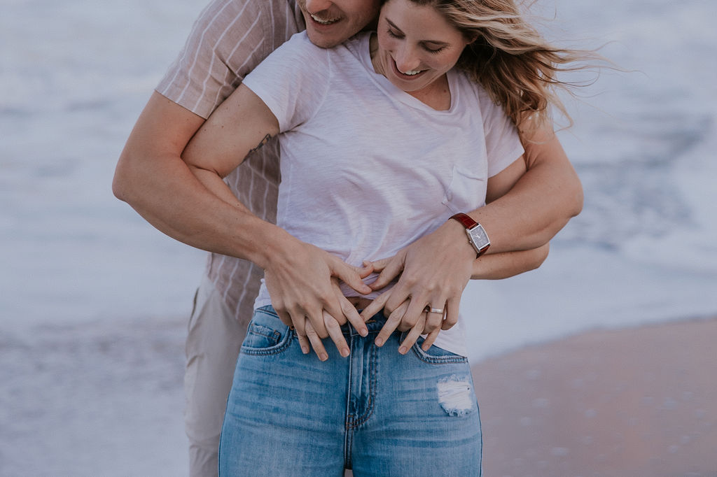 Destination Wedding Photographer captures man and woman touching woman's belly during Indian Harbour Maternity Photos