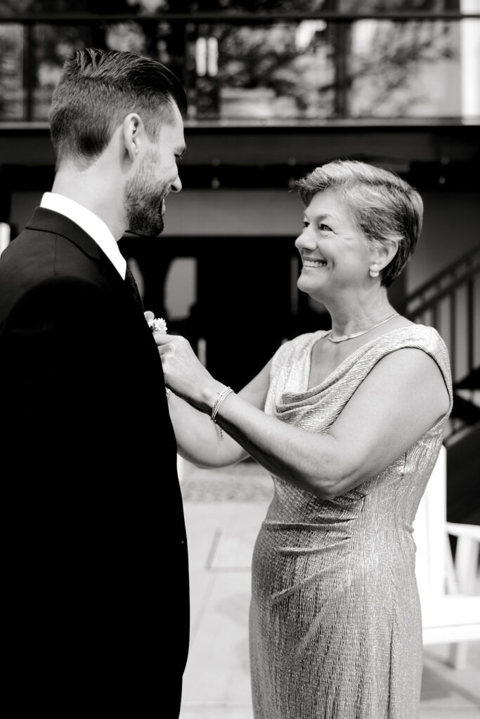 Destination wedding photographer captures mother helping groom before romantic minnesota wedding