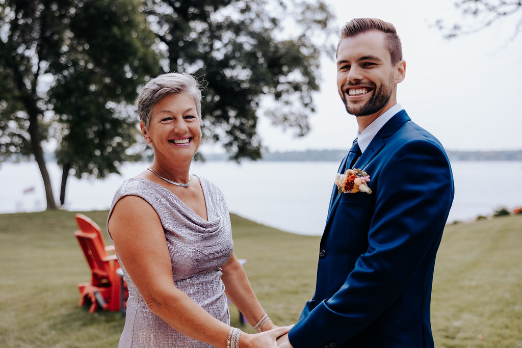 Destination wedding photographer captures groom with his mother holding hands