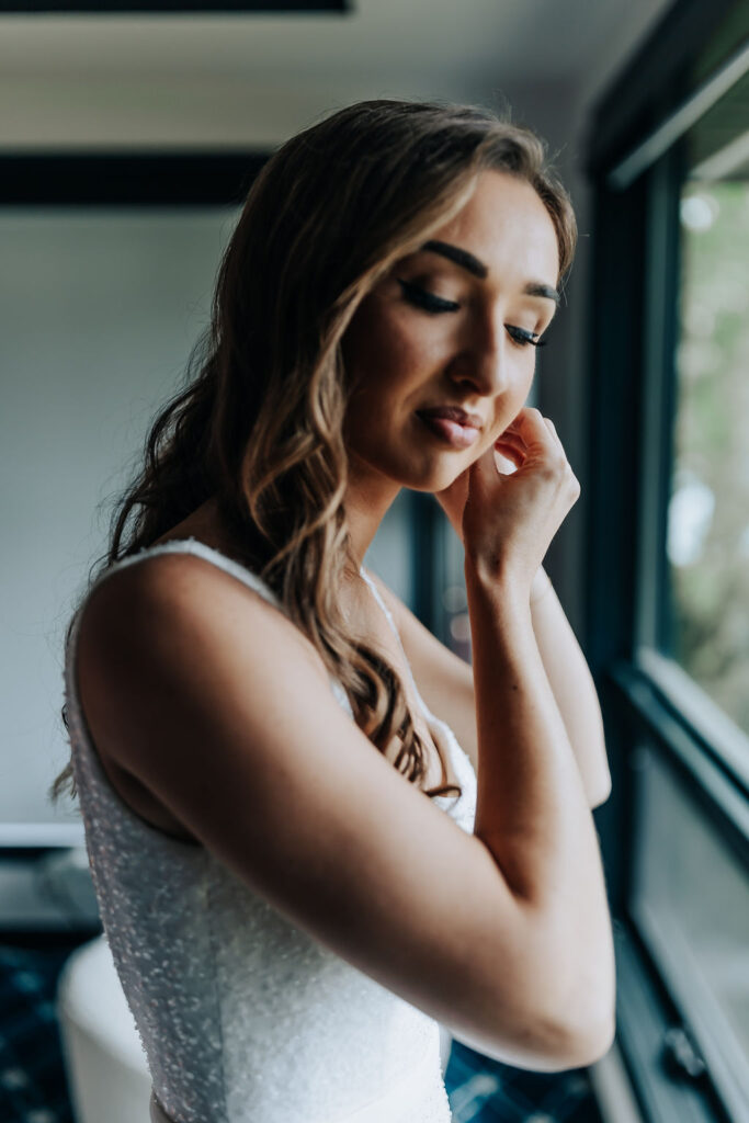 Destination Wedding Photographer captures bride putting on earrings