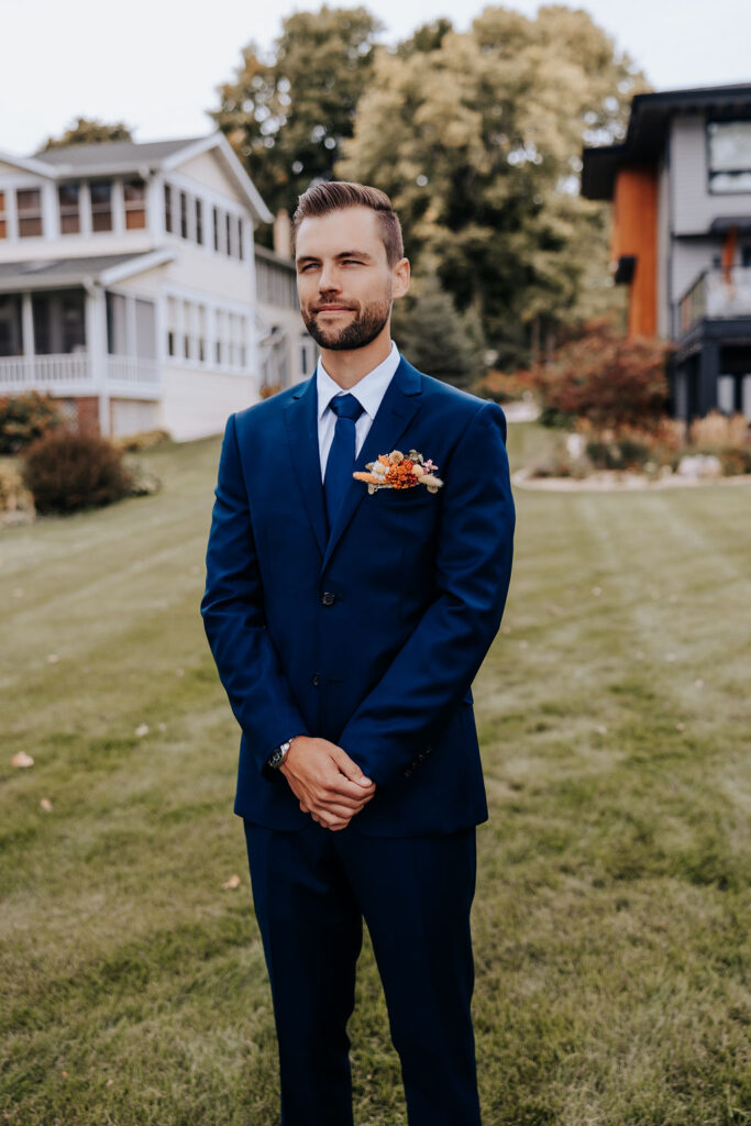 Destination wedding photographer captures groom standing waiting for his bride