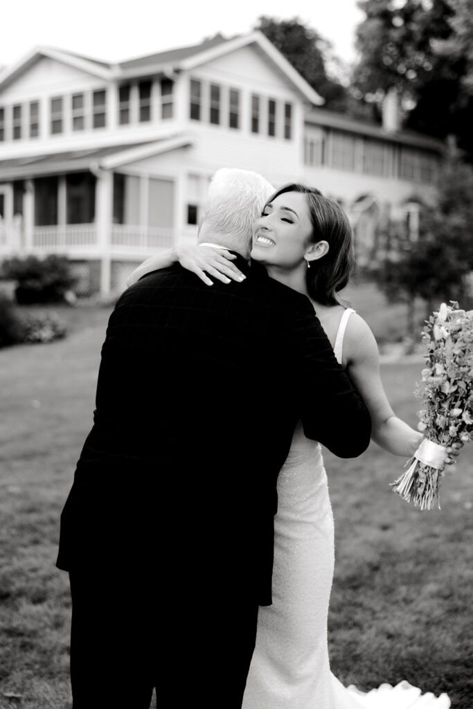 Destination wedding photographer captures bride hugging father after first look