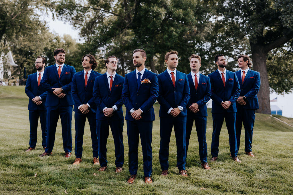 Destination wedding photographer captures groom and groomsmen wearing navy suits