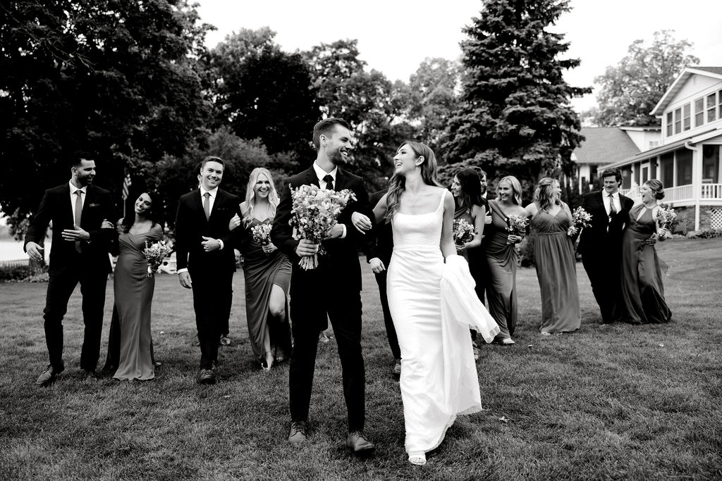 Destination wedding photographer captures bride and groom walking with wedding party