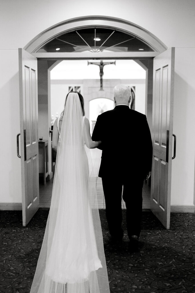 Destination wedding photographer captures bride and her father getting ready to walk her down the aisle