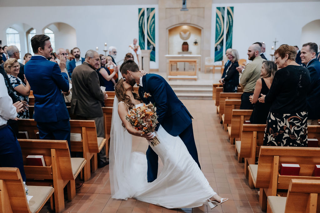 Destination wedding photographer captures bride and groom kissing after wedding ceremony