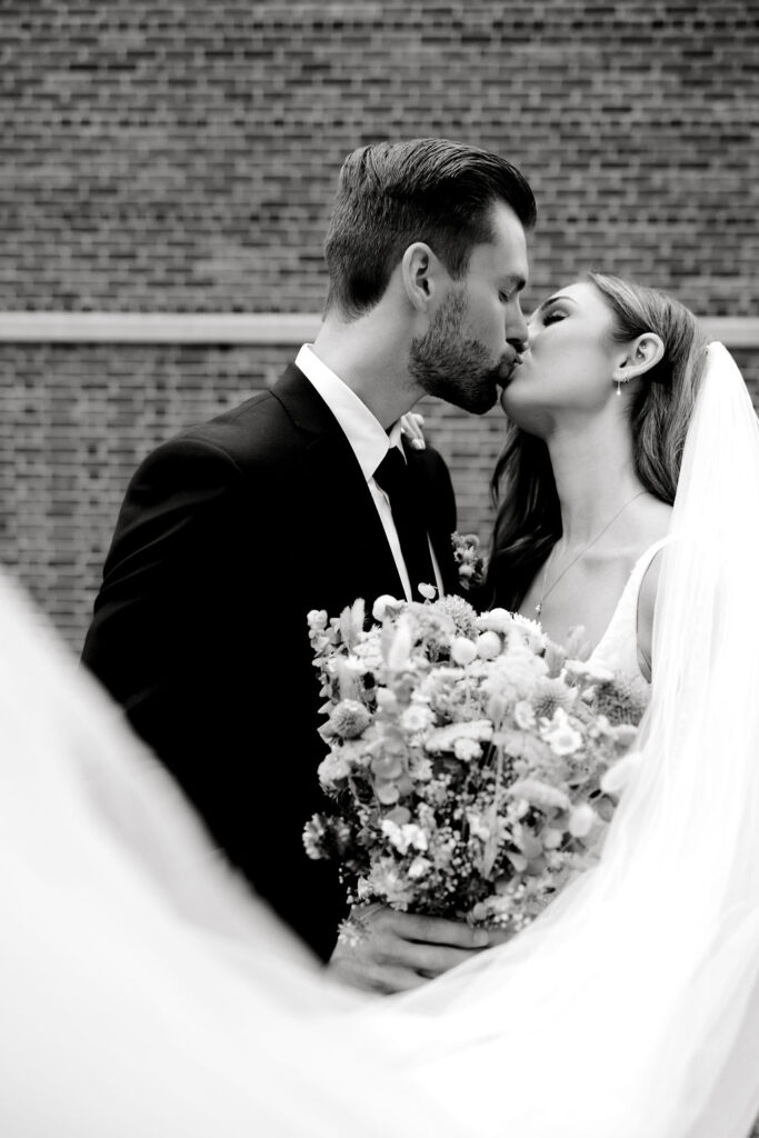 Destination wedding photographer captures bride and groom kissing