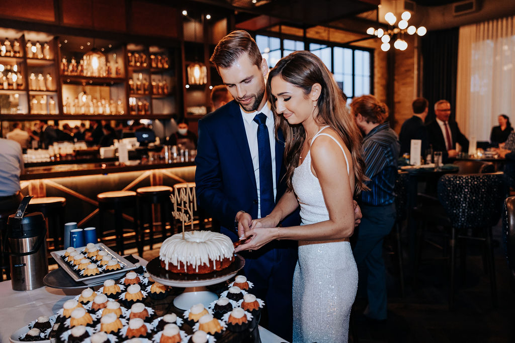 Destination wedding photographer captures bride and groom cutting cake