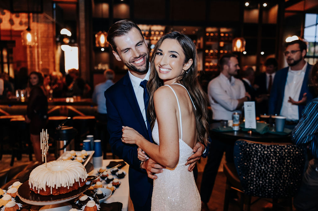 Destination wedding photographer captures bride and groom smiling after cake cutting