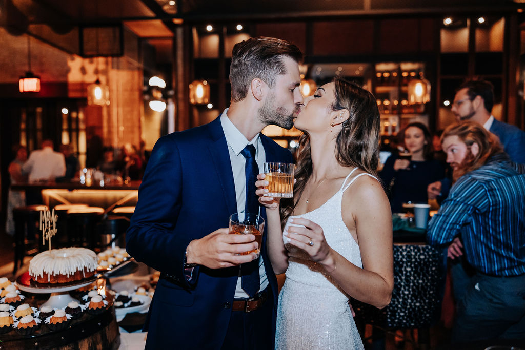 Destination wedding photographer captures couple kissing during wedding reception