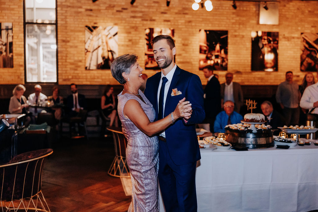 Destination wedding photographer captures groom dancing with mother