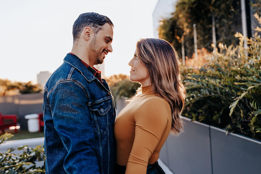 Nashville elopement photographer captures newly engaged couple looking at one another during fall date night ideas in Nashville