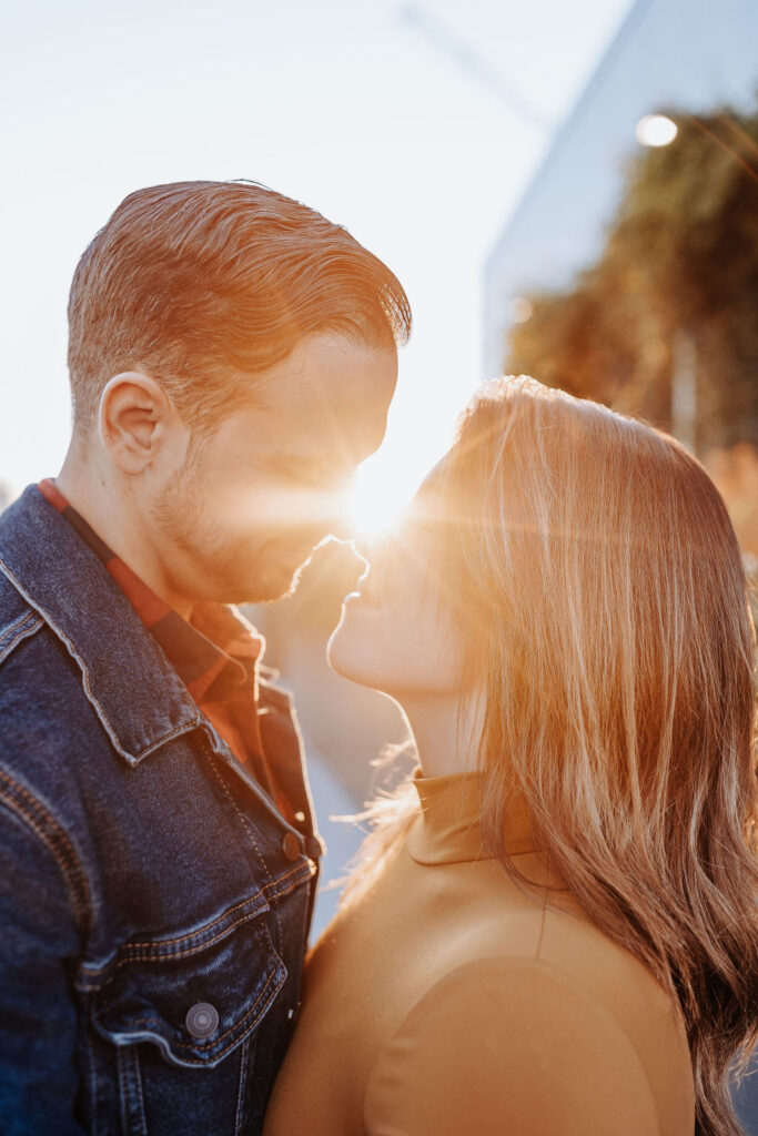 Nashville Elopement Photographer captures man and woman about to kiss with sunflare in between them