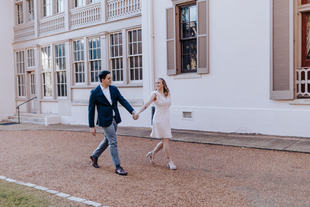 Destination Wedding Photographer captures man and woman walking together in downtown Nashville engagements