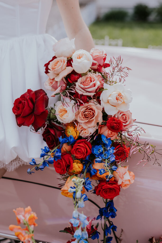 Nashville Elopement Photographer captures bride holding bouquet with roses and colorful florals in it