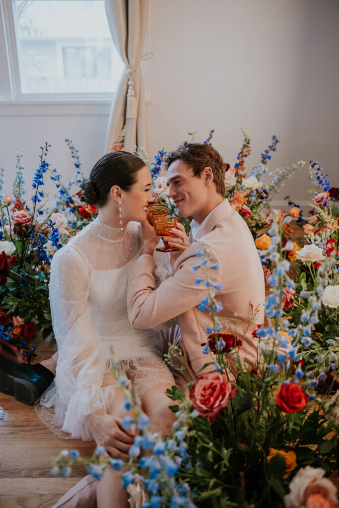 Nashville Elopement Photographer captures bride and groom sitting on floor surrounded by flowers