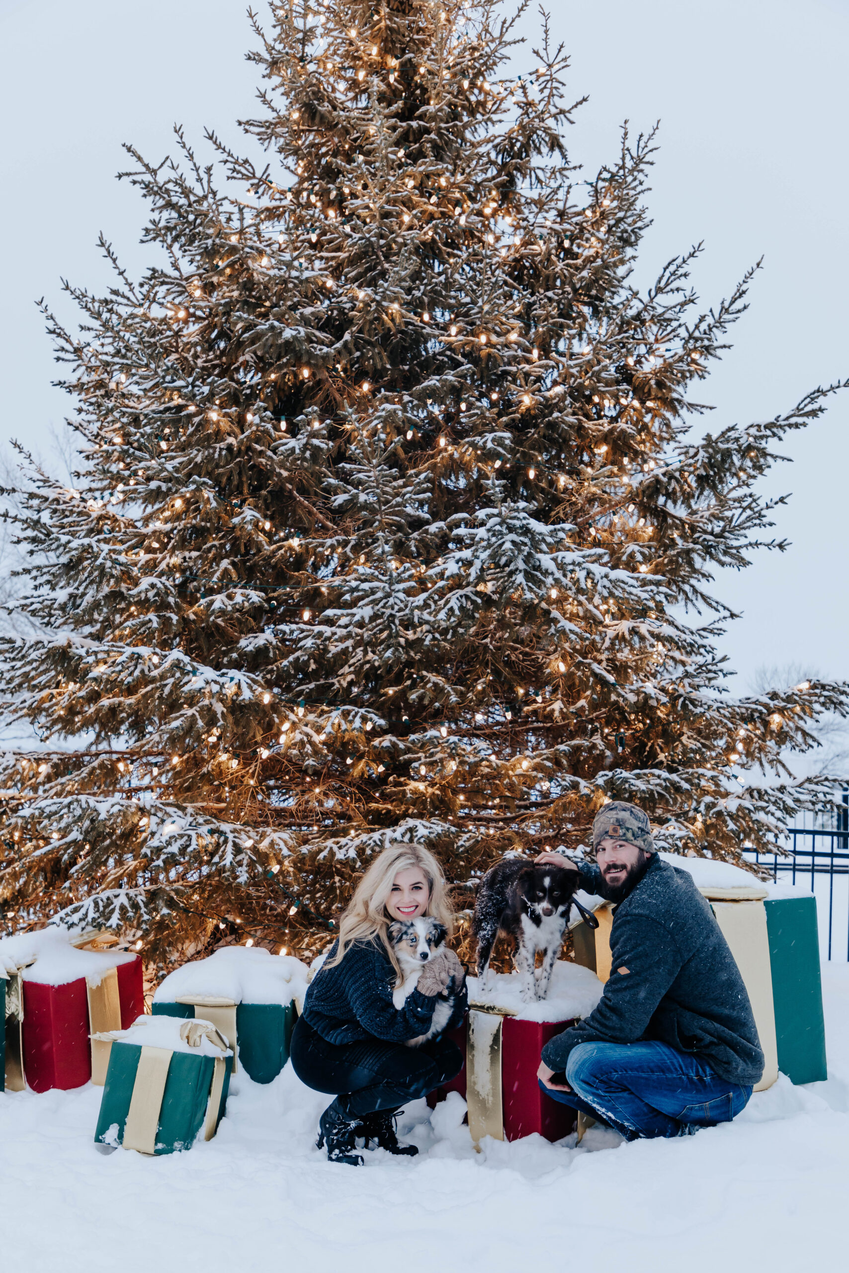 Destination Wedding Photographer captures couple in front of huge christmas tree and gifts