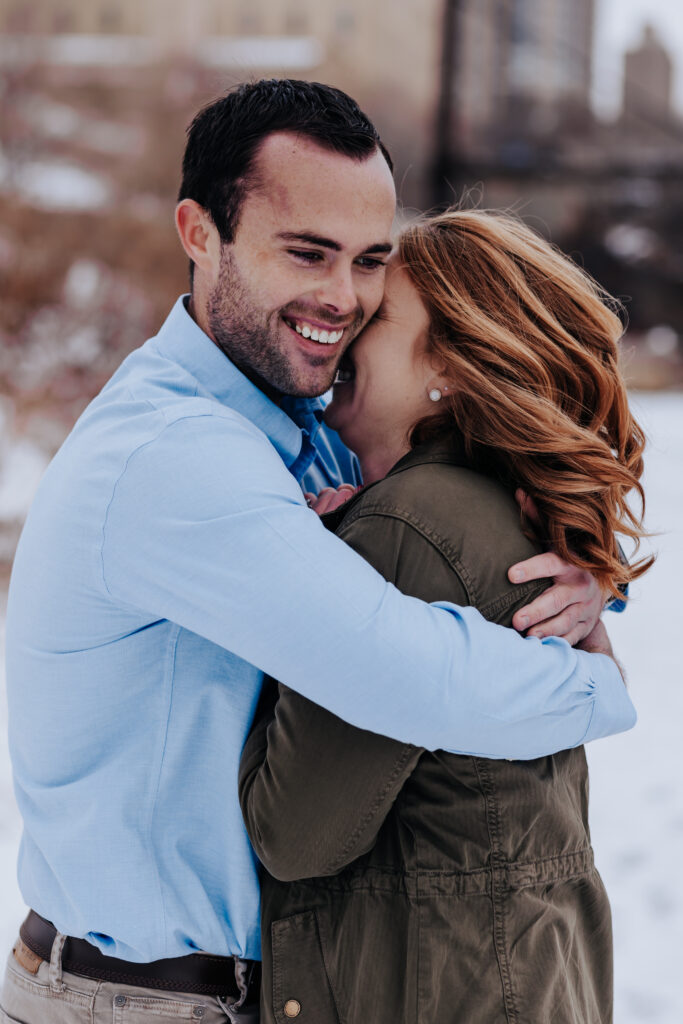 Destination Wedding Photographer captures woman and man laughing while hugging outdoors