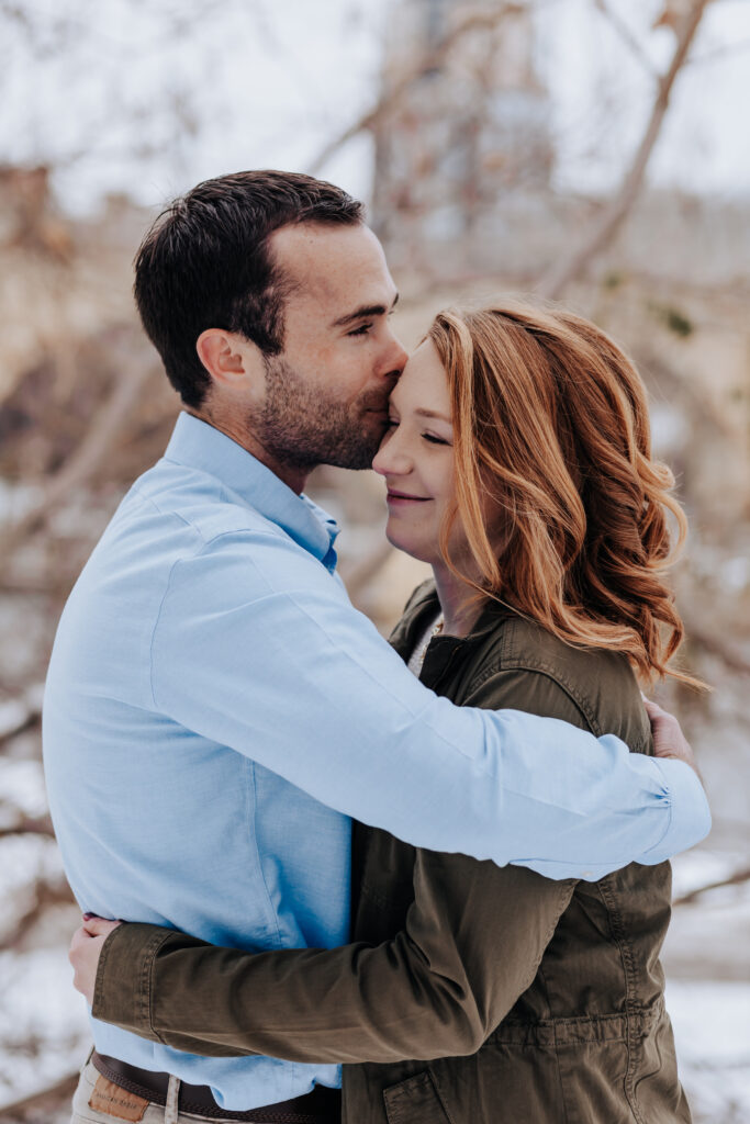 Destination Wedding Photographer captures man kissing woman's forehead