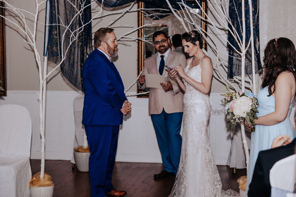 Nashville Elopement Photographer captures bride reading vows during intimate wedding ceremony at Carriage Lane Inn