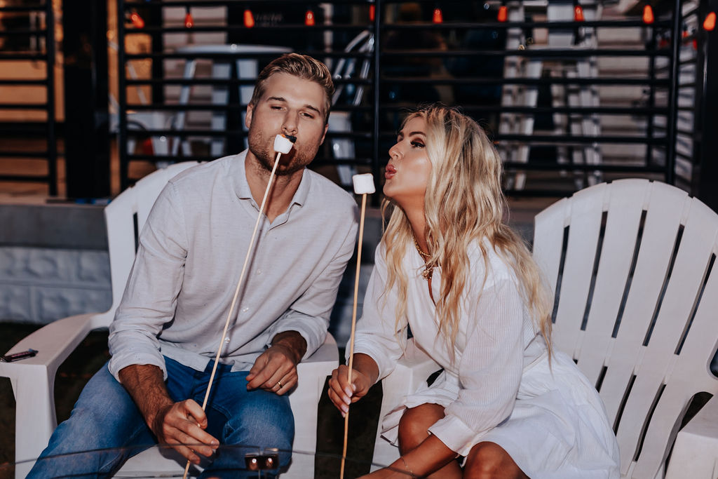 Nashville Engagement Photographer captures couple blowing on marshmallows