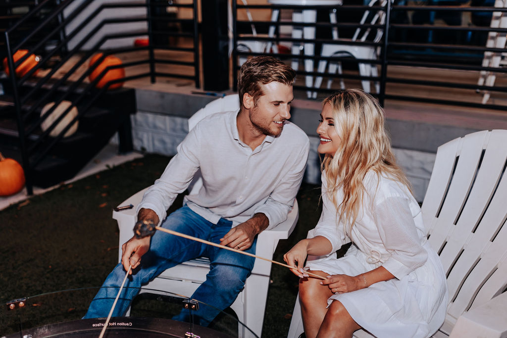 Nashville Engagement Photographer captures couple sitting together on chairs laughing together