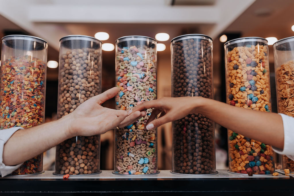 Nashville Engagement Photographer captures couple holding hands in front of cereal