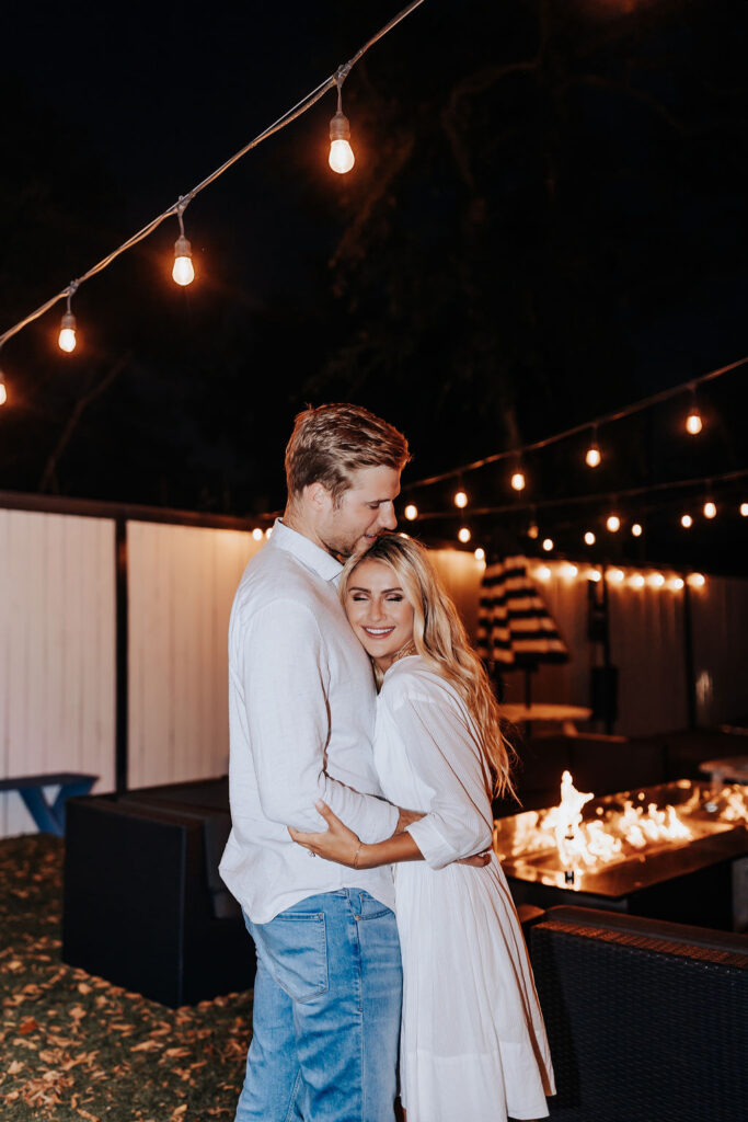 Nashville Engagement Photographer captures man and woman dancing in front of fire at Wanna Spoon in Nashville