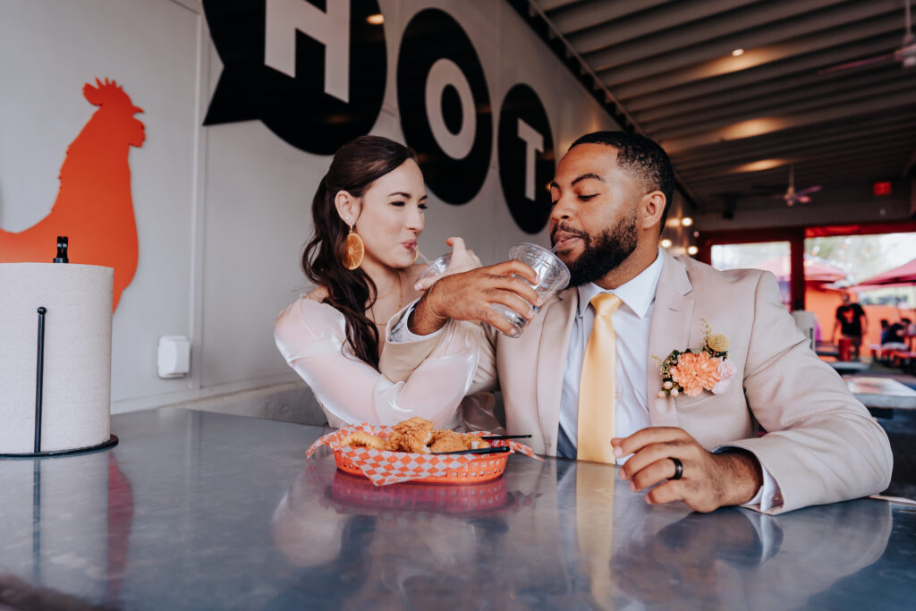 Destination Wedding Photographer captures bride and groom at Hattie B's after destination elopement in Nashville