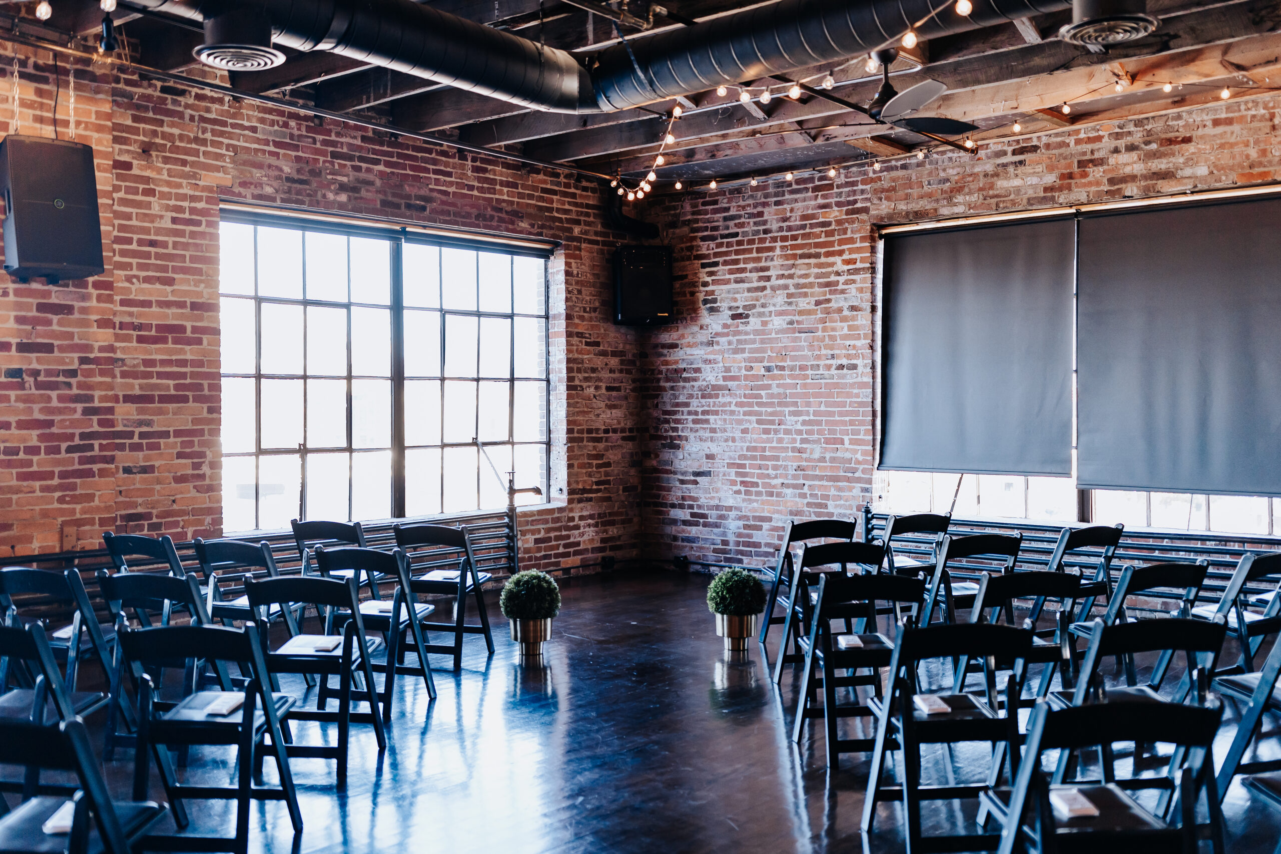 Destination Wedding Photographer captures indoor wedding venue with brick walls and chairs set up