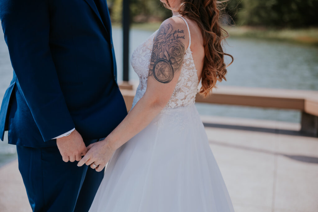 Nashville Elopement Photographer captures bride and groom holding hands with bride's arm showcasing tattooes