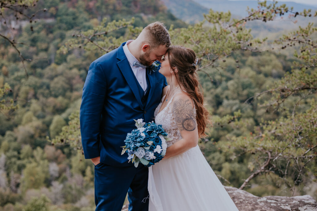 Nashville Elopement Photographer captures bride and groom touching foreheads while bride holding bouquet