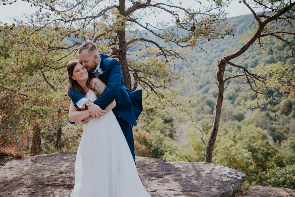 Nashville Elopement Photographer captures groom hugging bride from behind after they have a nashville elopement