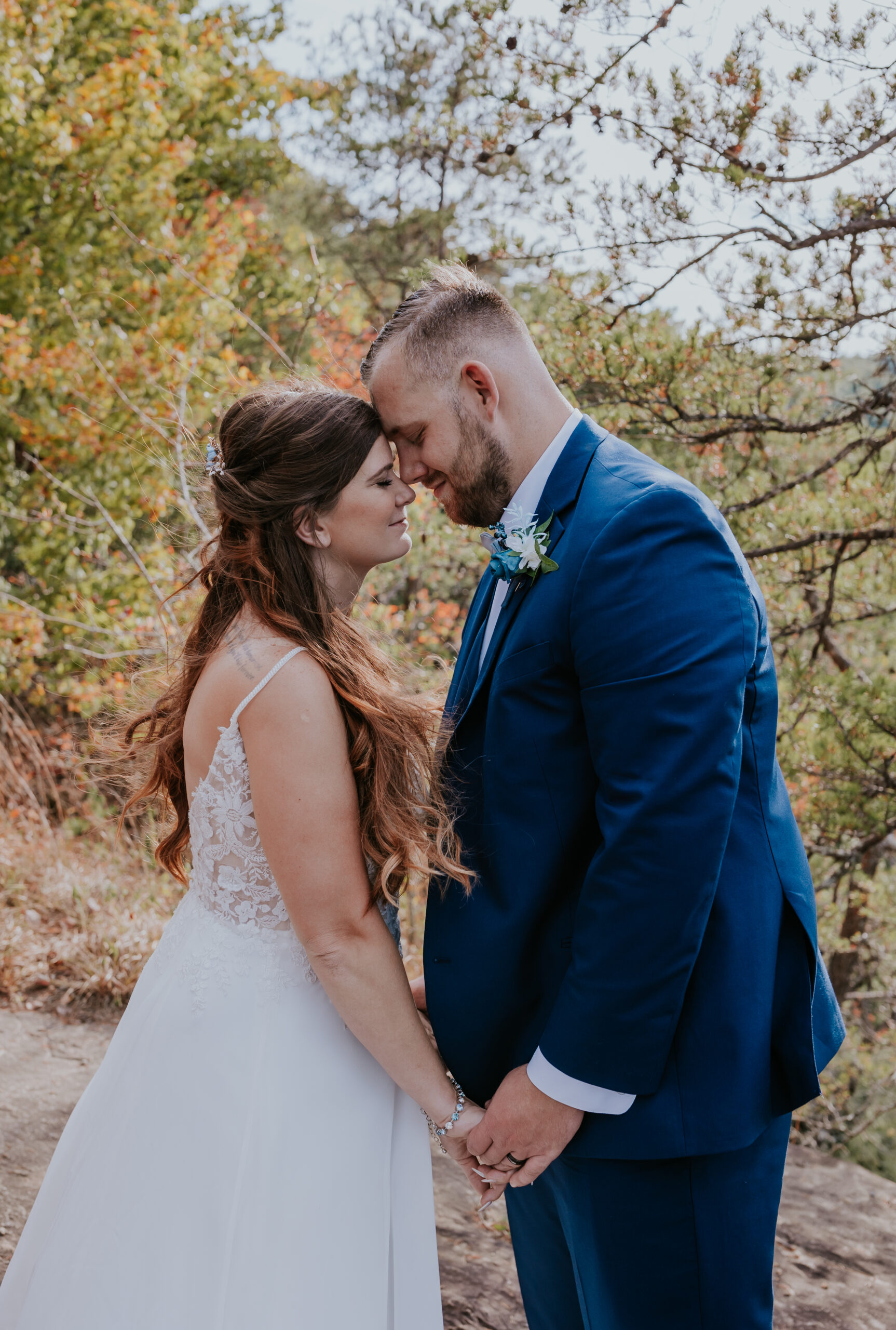 Outdoor wedding moment with bride and groom sharing an intimate forehead touch, one of the serene places to get married in Nashville TN.