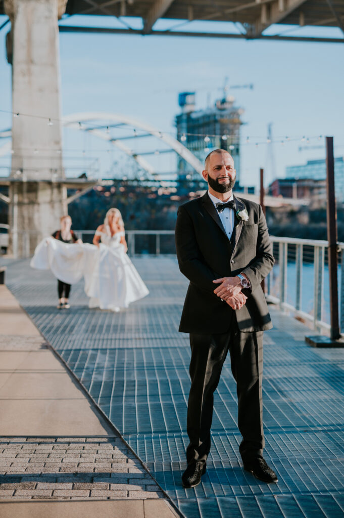 bride walking towards groom during first look