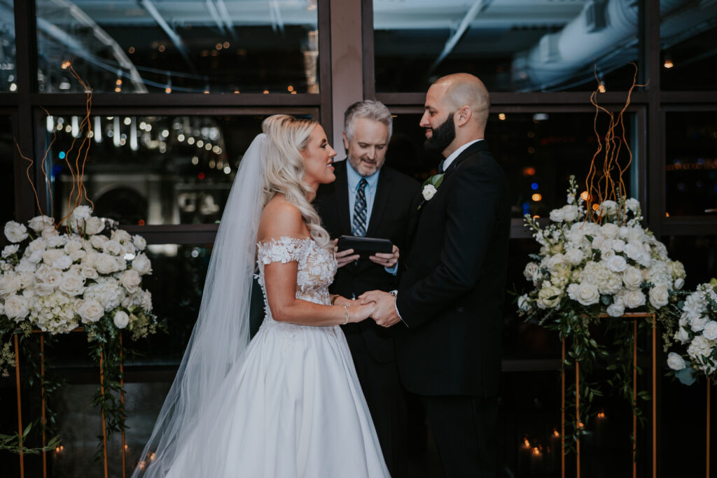 bride and groom holding hands at ceremony