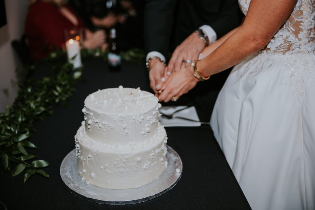 bride and groom cutting wedding cake at Bridge Building wedding